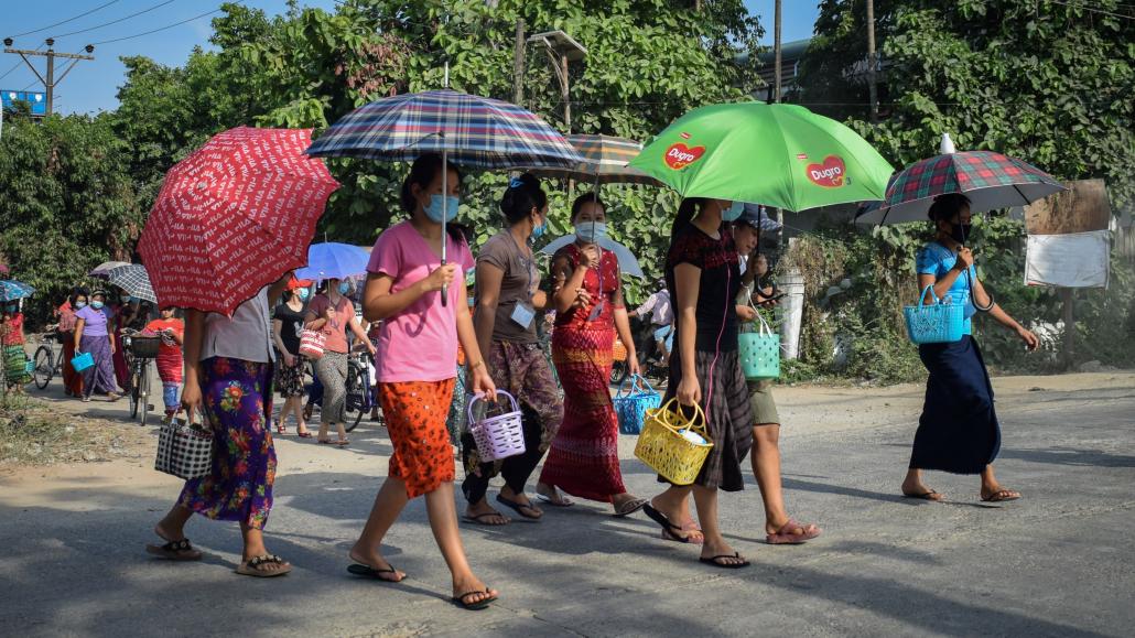 Workers at the Blue Diamond bag factory in Yangon’s Dagon Seikkan Township walk home on May 12. (Kyaw Lin Htoon | Frontier)