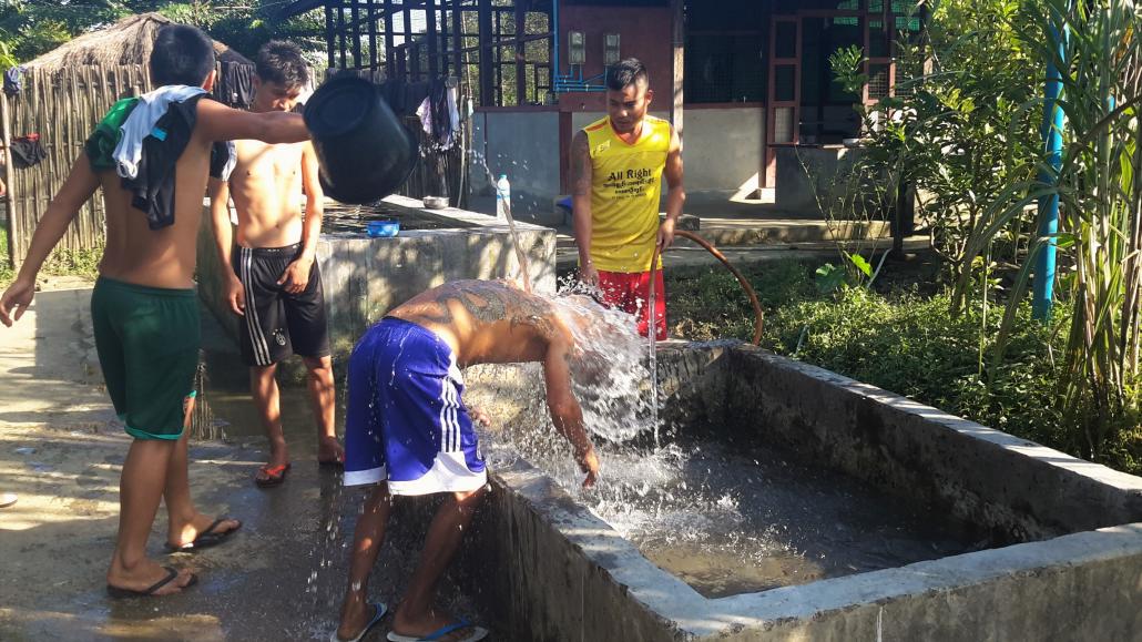 A drug user is given a cold bath to relieve his withdrawal symptoms at the Ram Hkye Shalat rehabilitation centre on Myitkyina's outskirts. (Supplied)