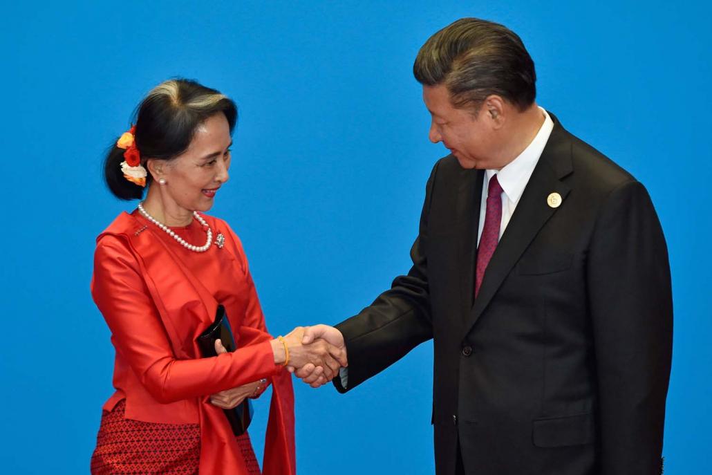 China's President Mr Xi Jinping shakes hands with State Counsellor Daw Aung San Suu Kyi at the welcome ceremony for the Belt and Road Forum in Beijing on May 15, 2017. (AFP)