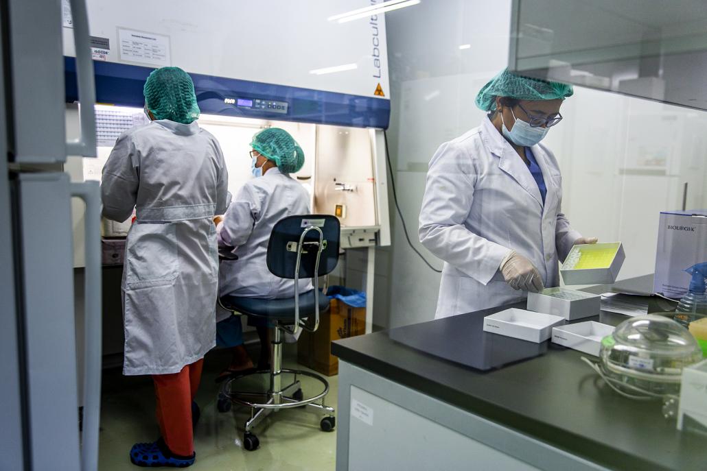 Medical workers prepare samples to be tested on an RT-PCR machine at the Department of Medical Research laboratory in Yangon on May 21. (Hkun Lat | Frontier)