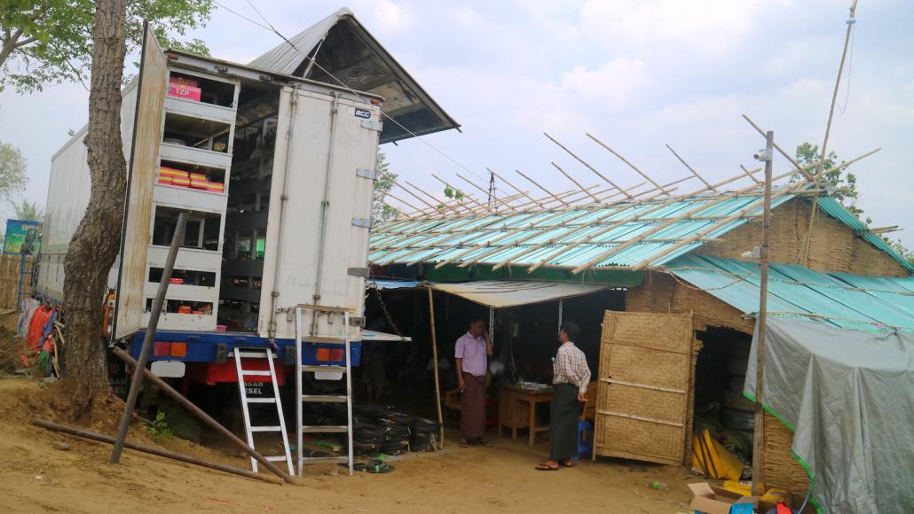 A mobile shop at the sprawling field of Thabyenyo, which barely existed two years ago. Many shops have closed and sales are down at those that have remained open. (Nay Aung | Frontier)