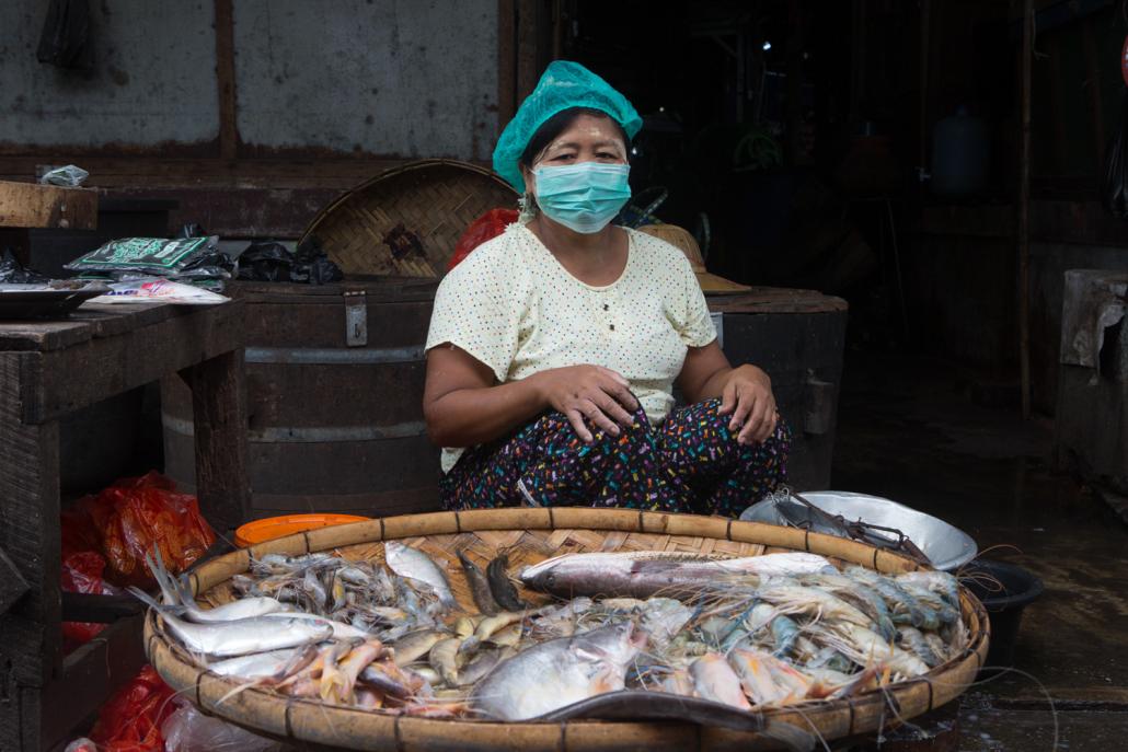 Fish vendor Daw Hla Hla waits for customers at Insein Market. (Thuya Zaw | Frontier)