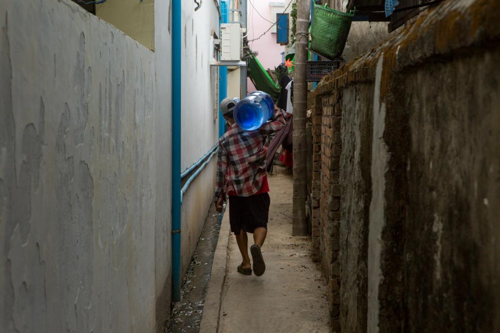 The 20-litre plastic barrels of drinking water delivered daily to homes and business are often inadequately cleaned before reuse. (Thuya Zaw | Frontier)