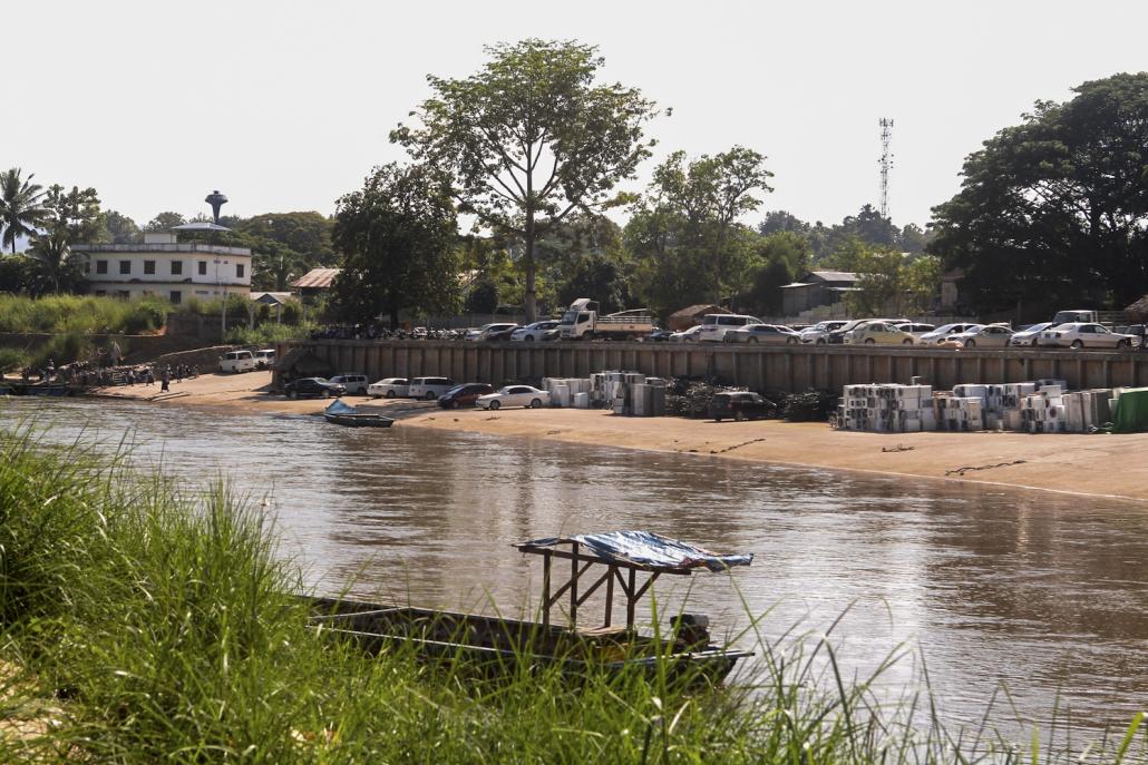 A Kayin State Border Guard Force operated trade gate in Myawaddy filled with cars and used whitegoods, as seen from the Thai side of the Thaung Yin River. (Thomas Kean | Frontier)