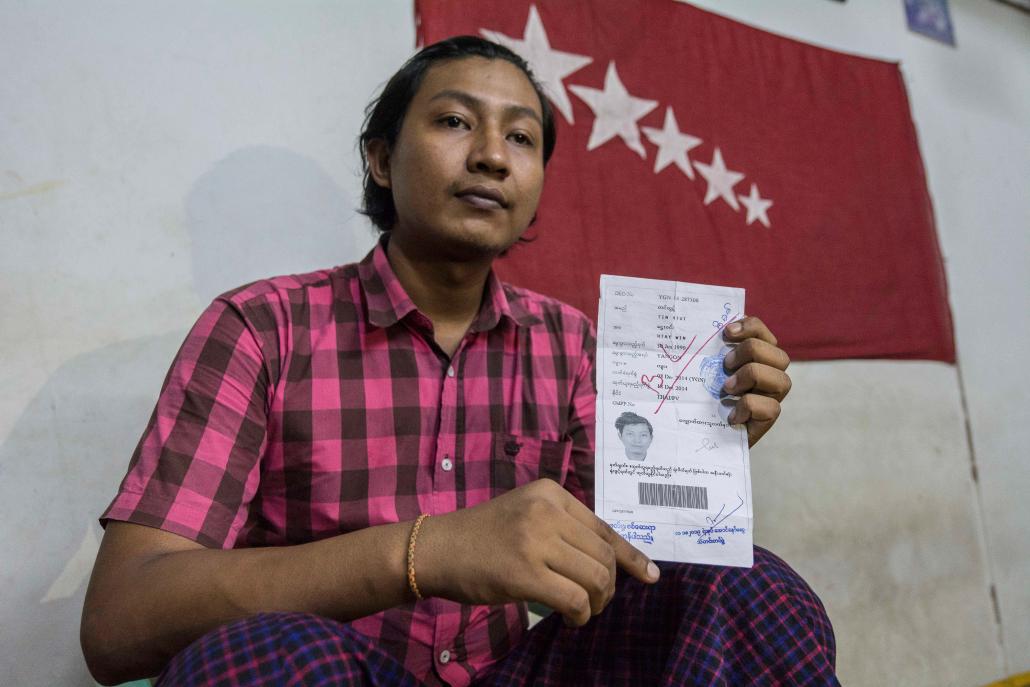 Activist Ko Tin Htut Paing shows his passport application, which was rejected because he is still on a government blacklist. (Teza Hlaing / Frontier)