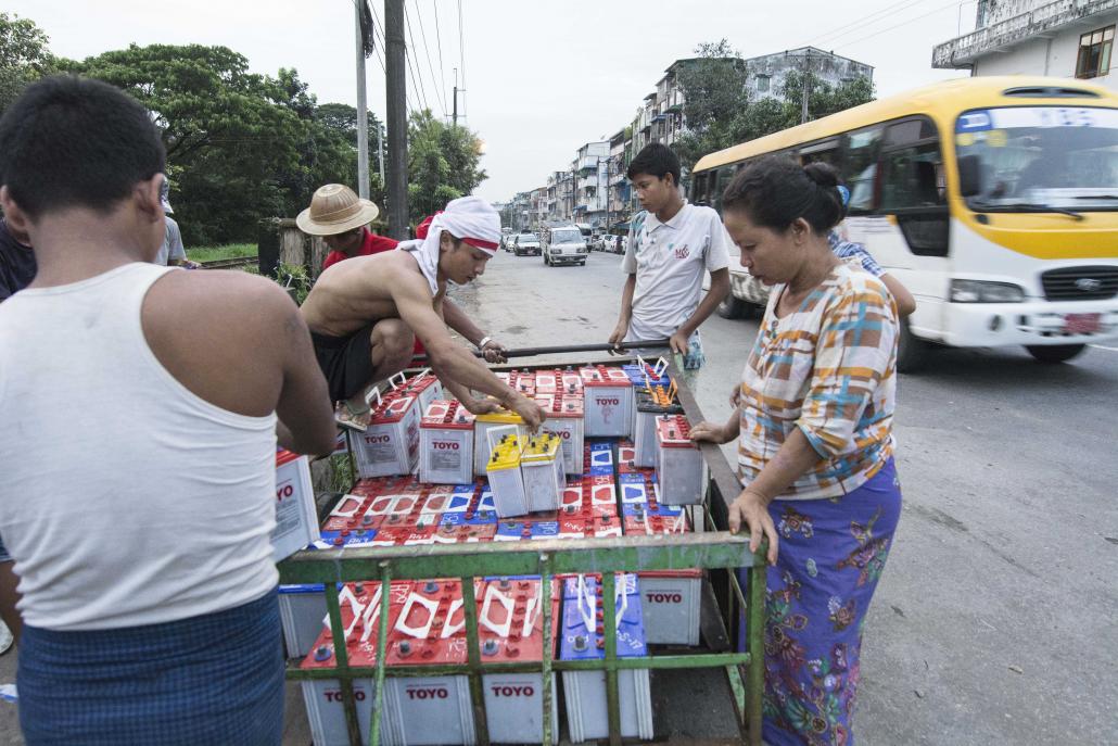 There are an estimated 450,000 squatters in Yangon, many of whom are not connected to the national grid. Most cannot afford to buy batteries or diesel generators so instead hire them on a daily basis. (Teza Hlaing | Frontier)