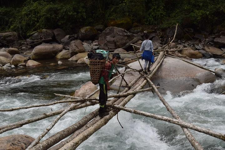 Local villagers cross a stream in Hkakabo Razi National Park. (Sanlu Ram Seng | Frontier)