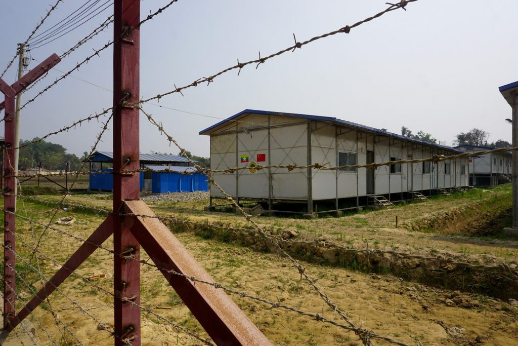 A processing camp for Rohingya Muslims pasted with Myanmar and Chinese flag stickers is seen in Maungdaw in Rakhine State in March 2018. (Joe Freeman | AFP)