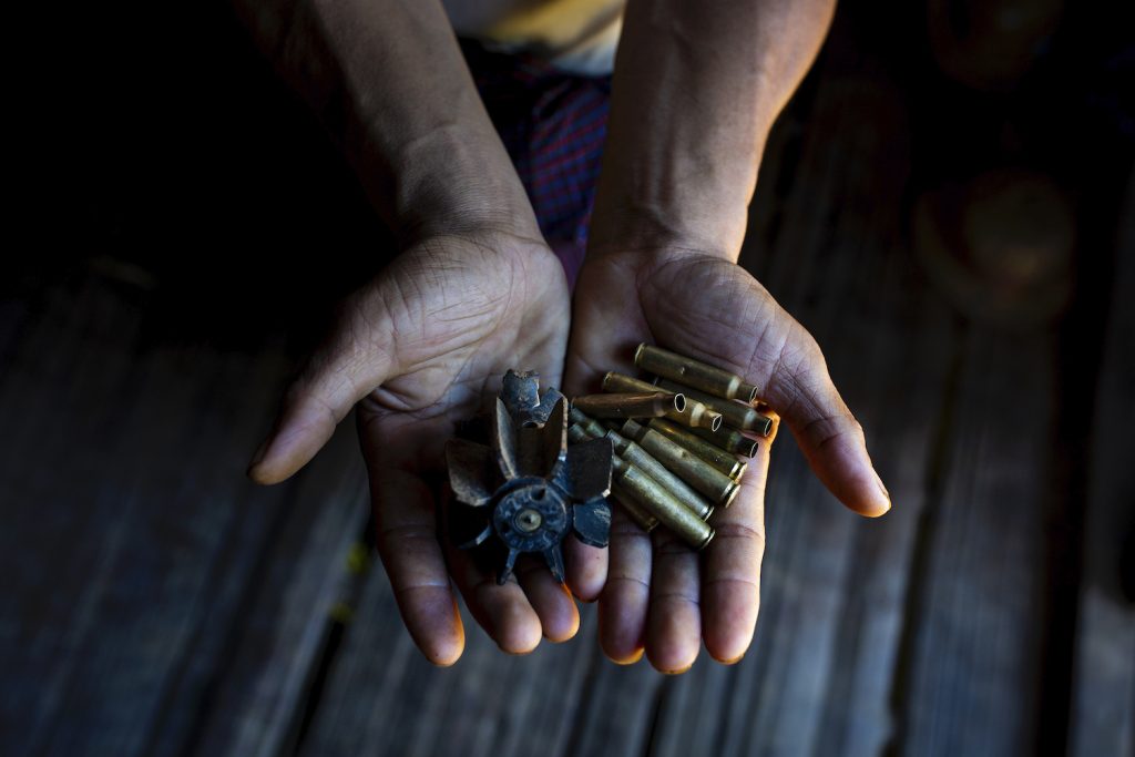 A villager holds out bullet shells collected from Pang Kyin village in Shan State's Kyaukme Township on August 4. (Hkun Lat | Frontier)