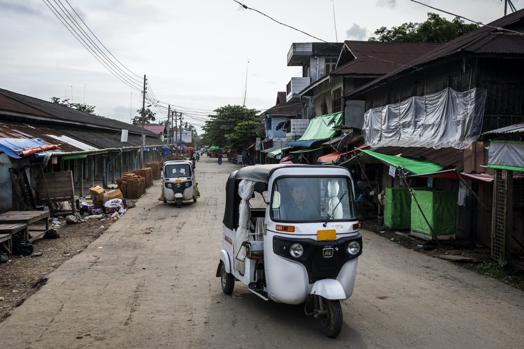 A three-wheeled motorbike taxi idles on a normally busy street in Mrauk-U, where 14 new COVID-19 cases have been confirmed. (Hkin Lat | Frontier)