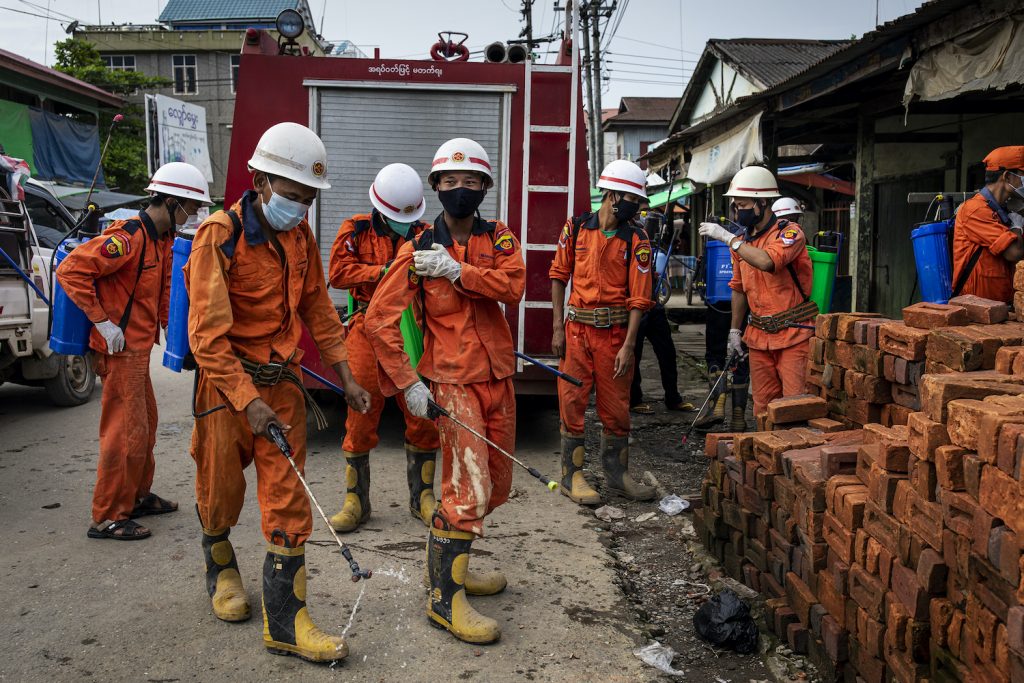 Firefighters prepare to disinfect the Myoma Market in Mrauk-U on August 21, a day after the township recorded its first confirmed case of COVID-19. (Hkun Lat | Frontier)