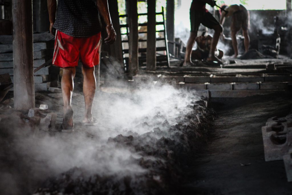 Employees at a small iron workshop in Bago Region work without even basic protective equipment. (Thomas Kean | Frontier)