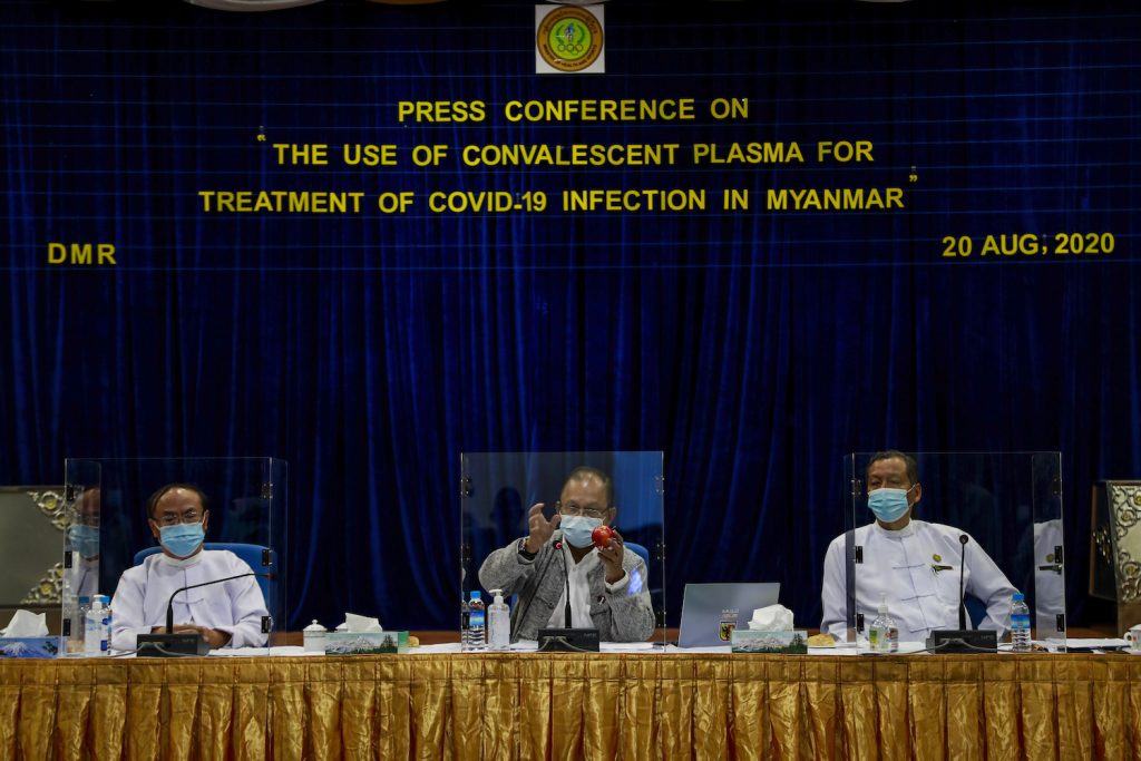 President of the Ad-hoc Advisory Committee for Convalescent Plasma Treatment Dr Rai Mra, middle, speaks on a panel at a conference in Yangon on August 29. (Nyein Su Wai Kyaw Soe | Frontier)