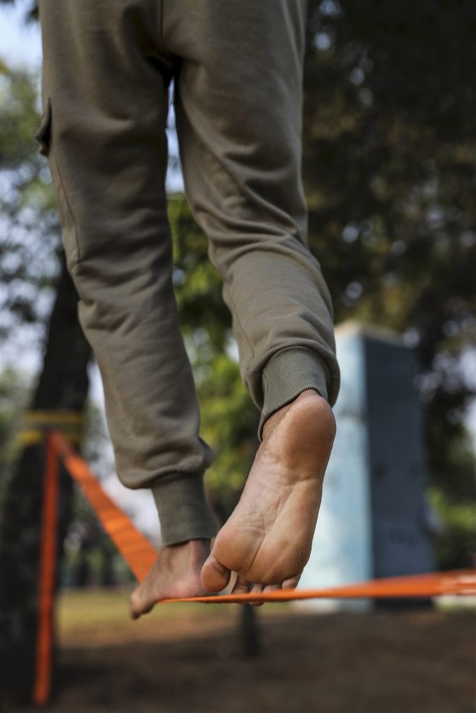 Ko Ye Win Tun walks across a slackline. (Nyein Su Wai Kyaw Soe | Frontier)