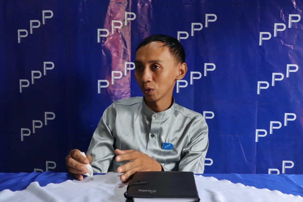 People's Pioneer Party candidate Myo Min Tun speaks to the media on September 12 at his Mandalay office. (AFP)