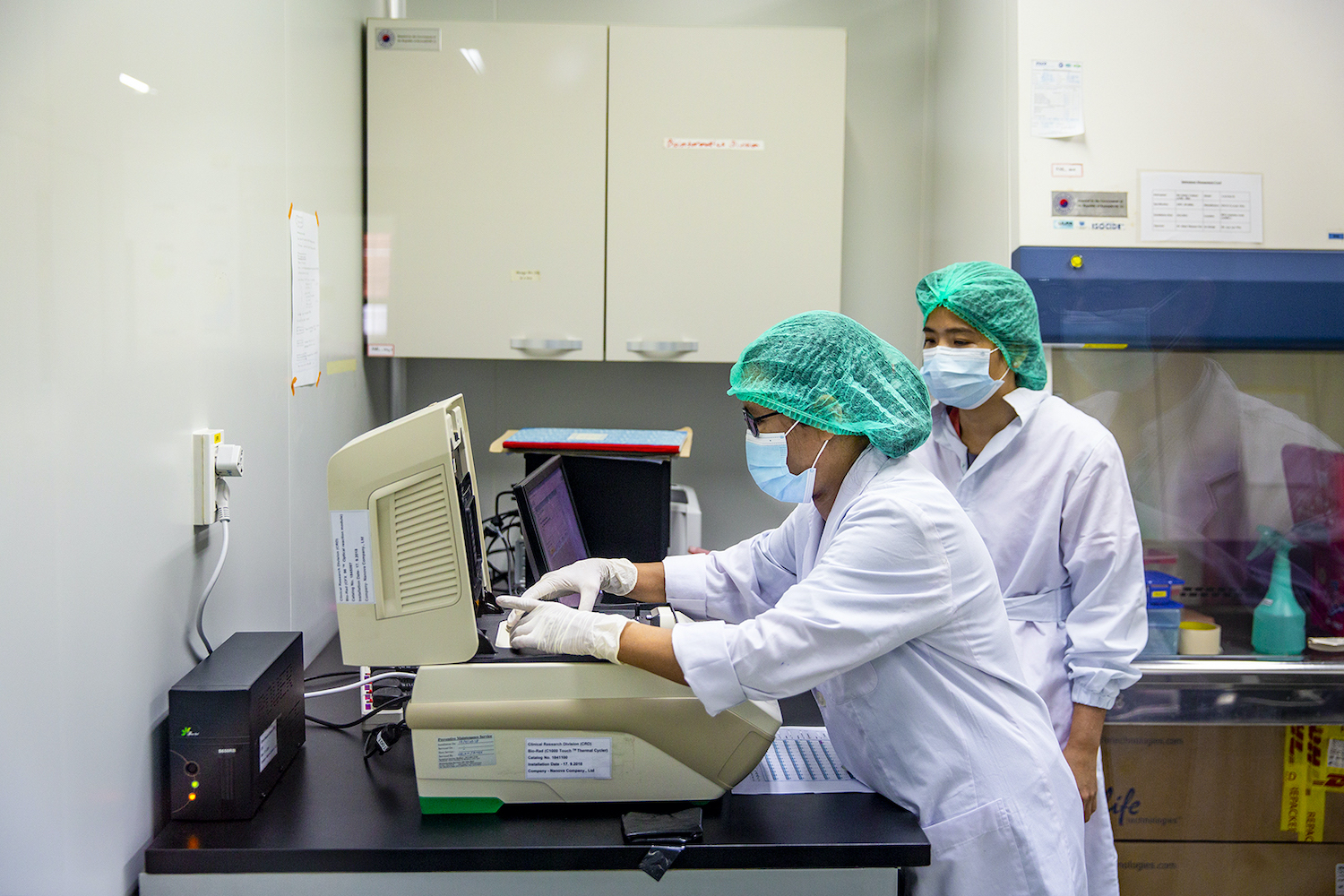 Lab technicians test COVID-19 samples at the Department of Medical Research's laboratory in Yangon on May 21, 2020. The country's COVID-19 response, including testing, has ground to a halt in the wakr of the February 1 coup. (Frontier)