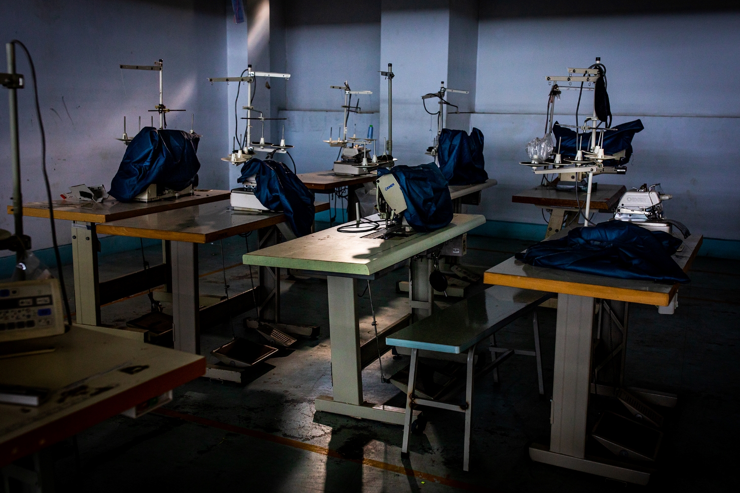 Sewing machines at an empty garment factory in Yangon that was closed in 2020 due to COVID-19. (Hkun Lat | Frontier)