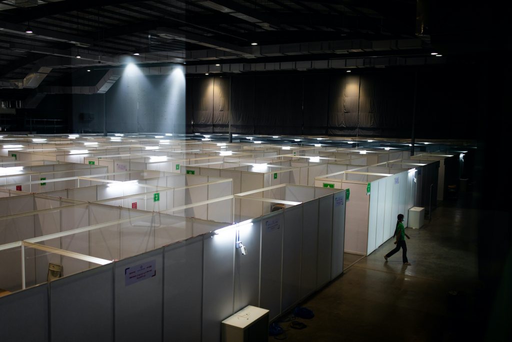 A worker exits a new, 500-capacity COVID-19 treatment centere at yjr Yangon Convention Center on October 7. (Hkun Lat | Frontier)