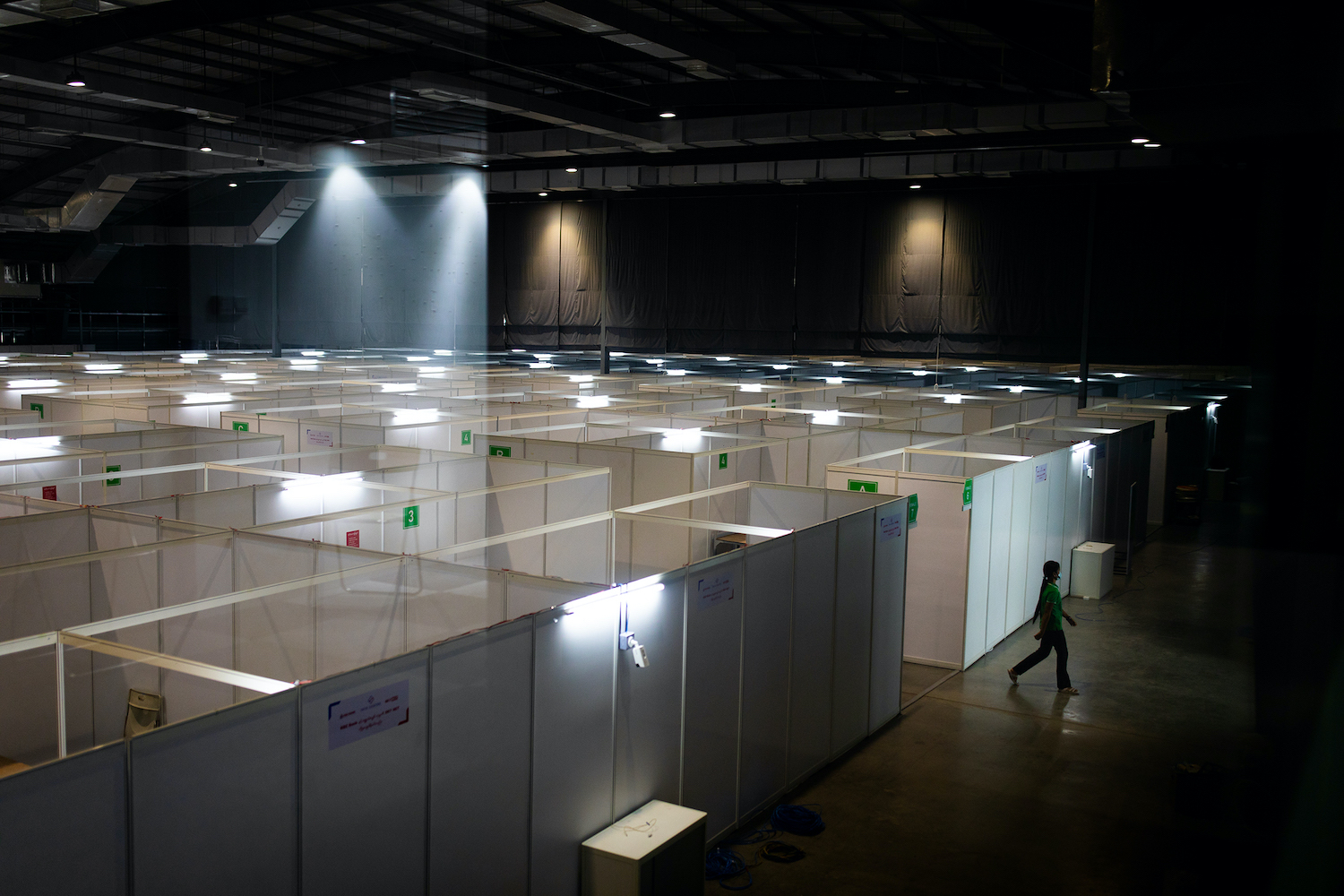 A worker exits a new, 500-capacity  COVID-19 treatment centere at yjr Yangon Convention Center on October 7. (Hkun Lat | Frontier)