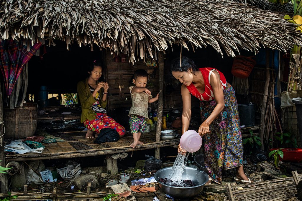 A woman washes clothes at a camp for internally displaced persons in Myothit monastery in Mrauk-U, Rakhine State on August 21. (Hkun Lat | Frontier)