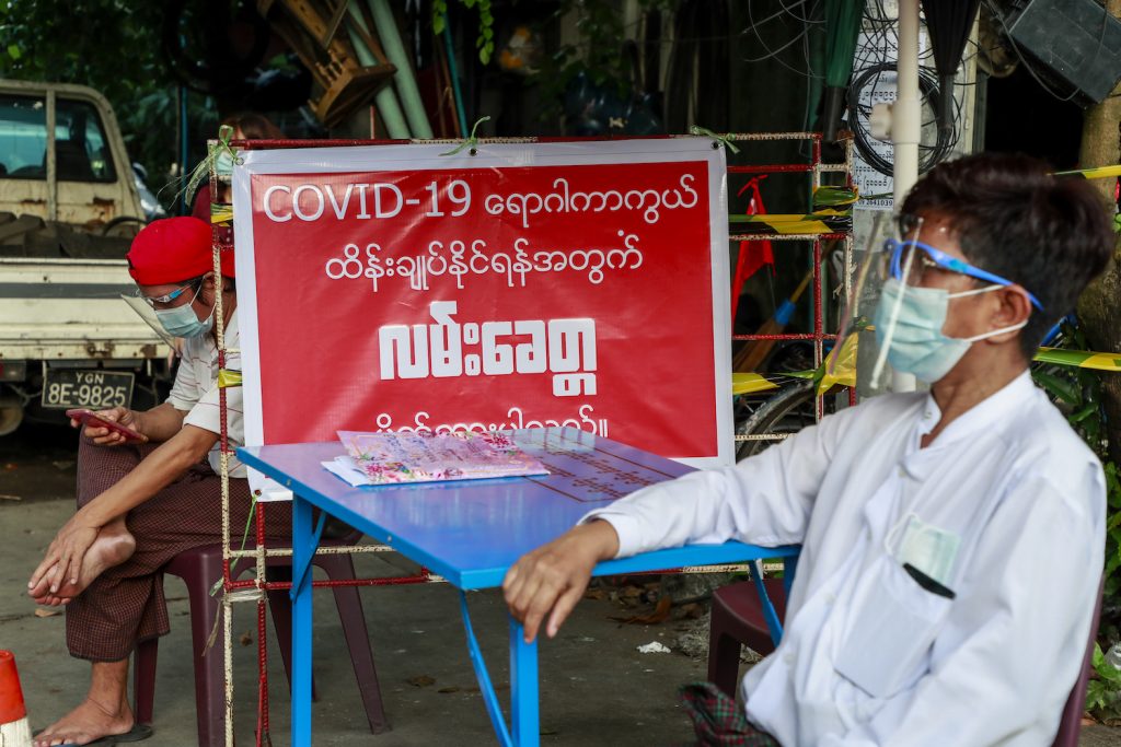 Residents man an informal checkpoint at the entrance to a street in Yangon's Sanchaung Township on September 11 after the government announced stay-at-home orders for most of the city. (Nyein Su Wai Kyaw Soe | Frontier)