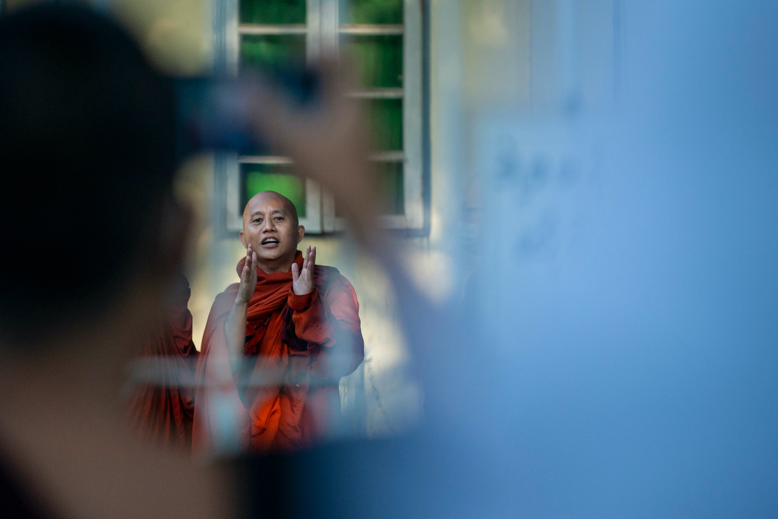 Buddhist monk Wirathu speaks to his followers before turning himself in at a Yangon police station on November 2. (AFP)