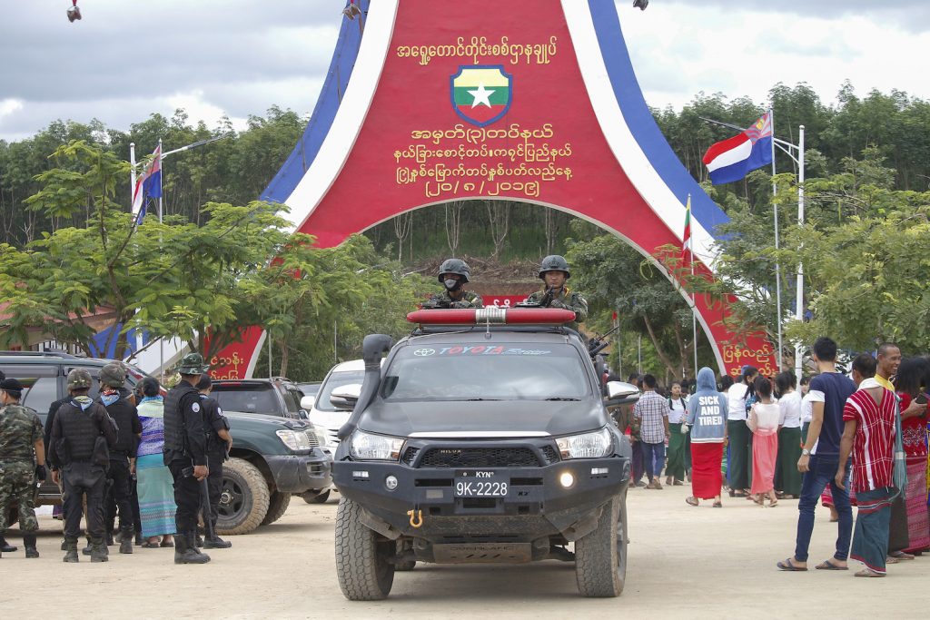 A car carrying Kayin State Border Guard Force soldiers passes under an archway at the parade ground in Shwe Kokko, Myawaddy Township, Kayin State in August 2019, when the group was celebrating its ninth anniversary. (Nyein Su Wai Kyaw Soe | Frontier)