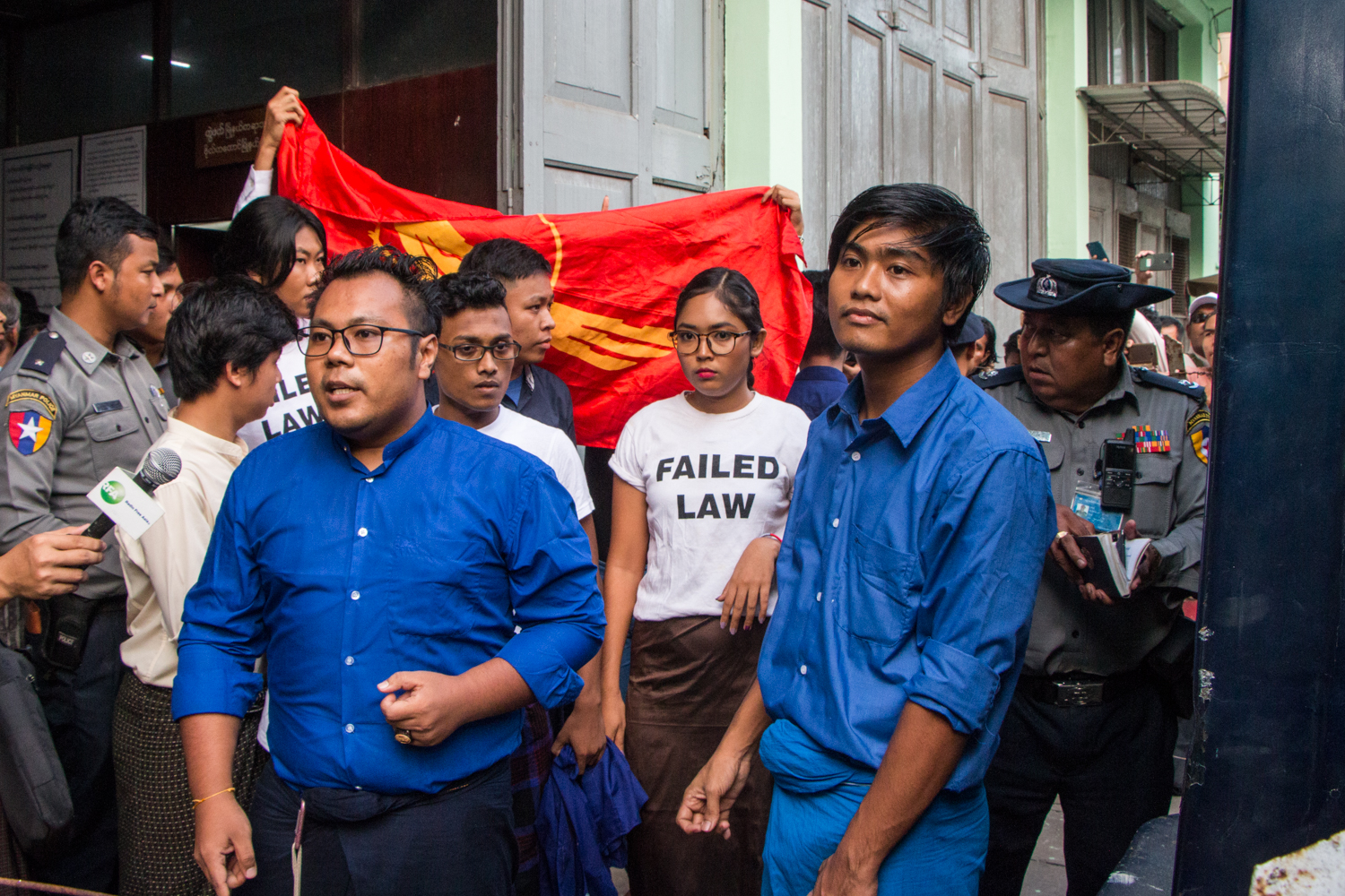 Members of the Peacock Generation, including Ma Su Yadanar Myint (centre), speak to the media after a hearing at Botahtaung Township Court on November 18, 2019. (Thuya Zaw | Frontier)