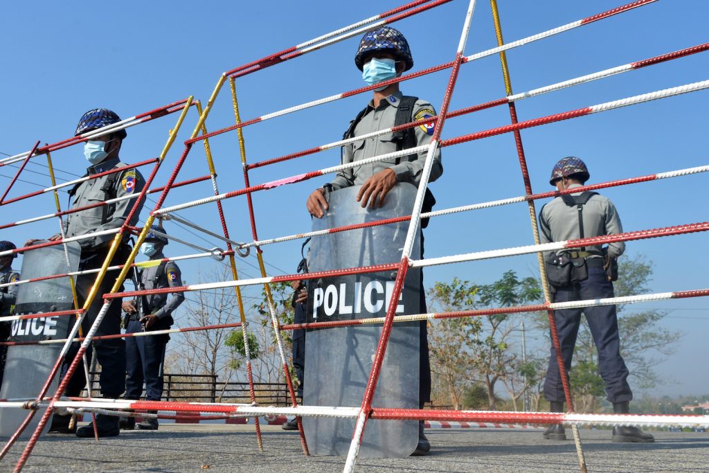 Police stand guard along a road in Nay Pyi Taw on January 29 ahead of the opening of the lower house of parliament on February 1. (AFP)