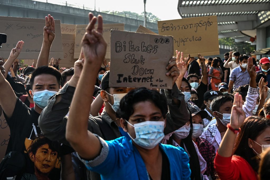 Protesters in Yangon hold placards denouncing the military's shutdown of the internet following the February 1 military coup. (AFP)