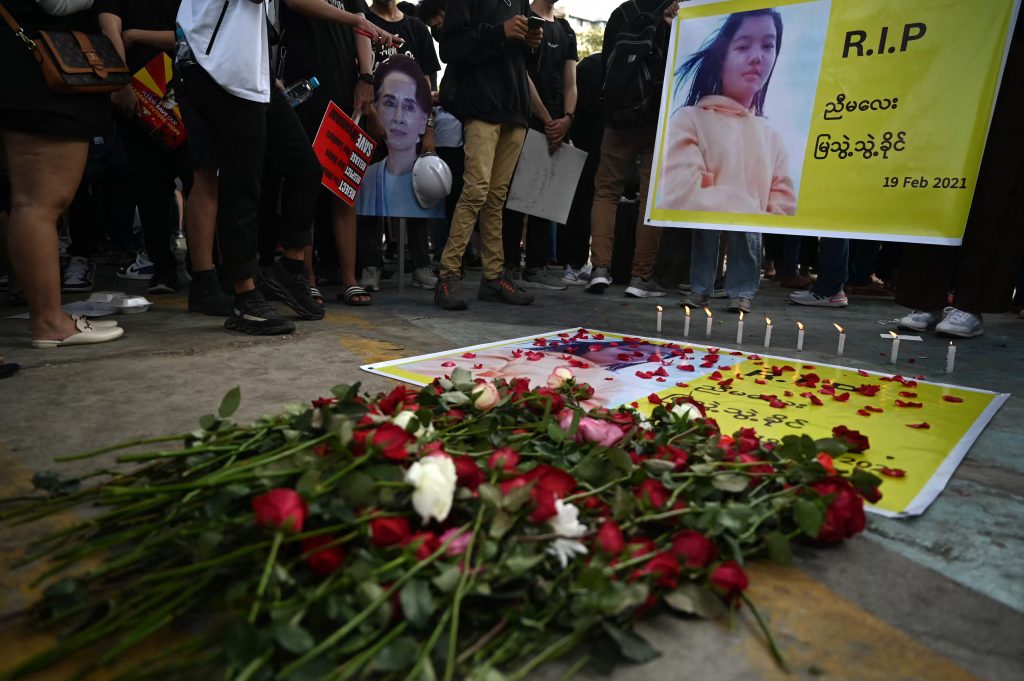 Flowers are placed next to a banner during a memorial for Ma Mya Thwate Thwate Khaing in Yangon on February 20. The young woman died from a gunshot wound sustained during a rally against the military on February 9. (AFP)
