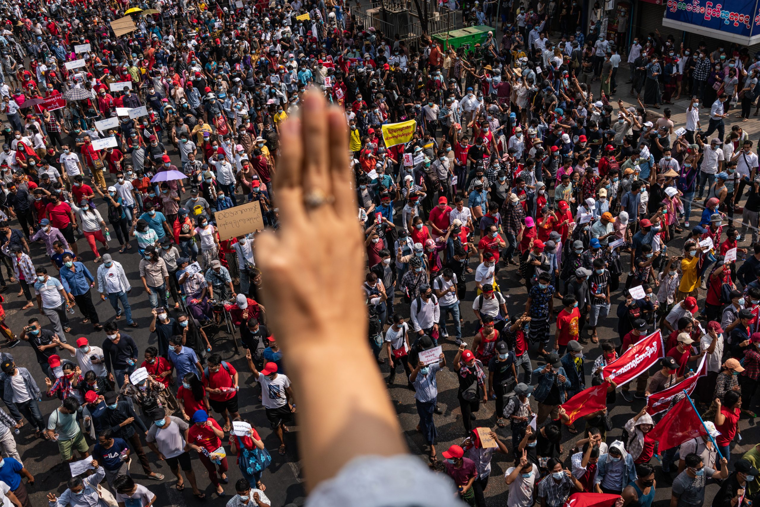 A man gives the three-finger salute to thousands of demonstrators in downtown Yangon on February 7. (Frontier)