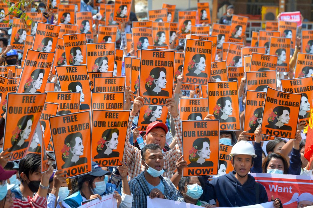 Protesters hold posters with the image of detained civilian leader Daw Aung San Suu Kyi during a demonstration against the military coup in Nay Pyi Taw on February 28. (AFP)