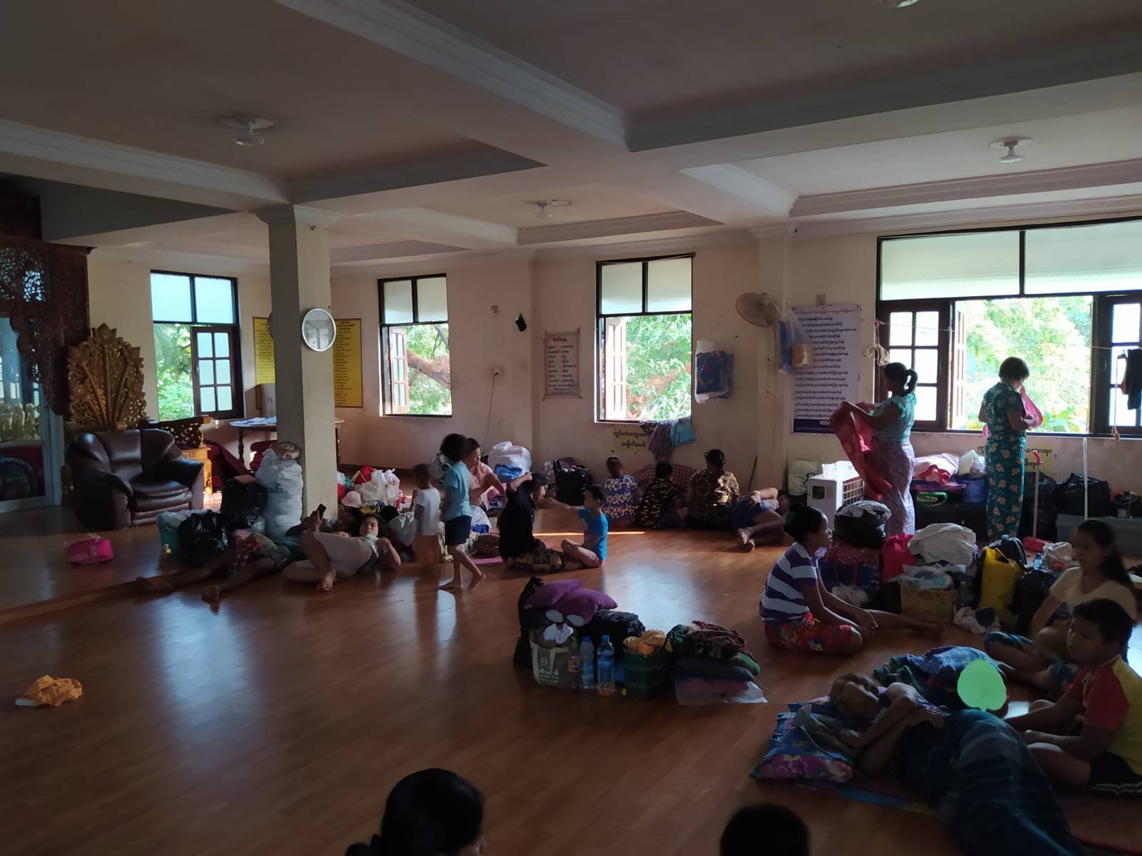 Families evicted by the military from a Myanma Railways staff housing complex in Yangon shelter at a nearby monastery on March 16. (Frontier)