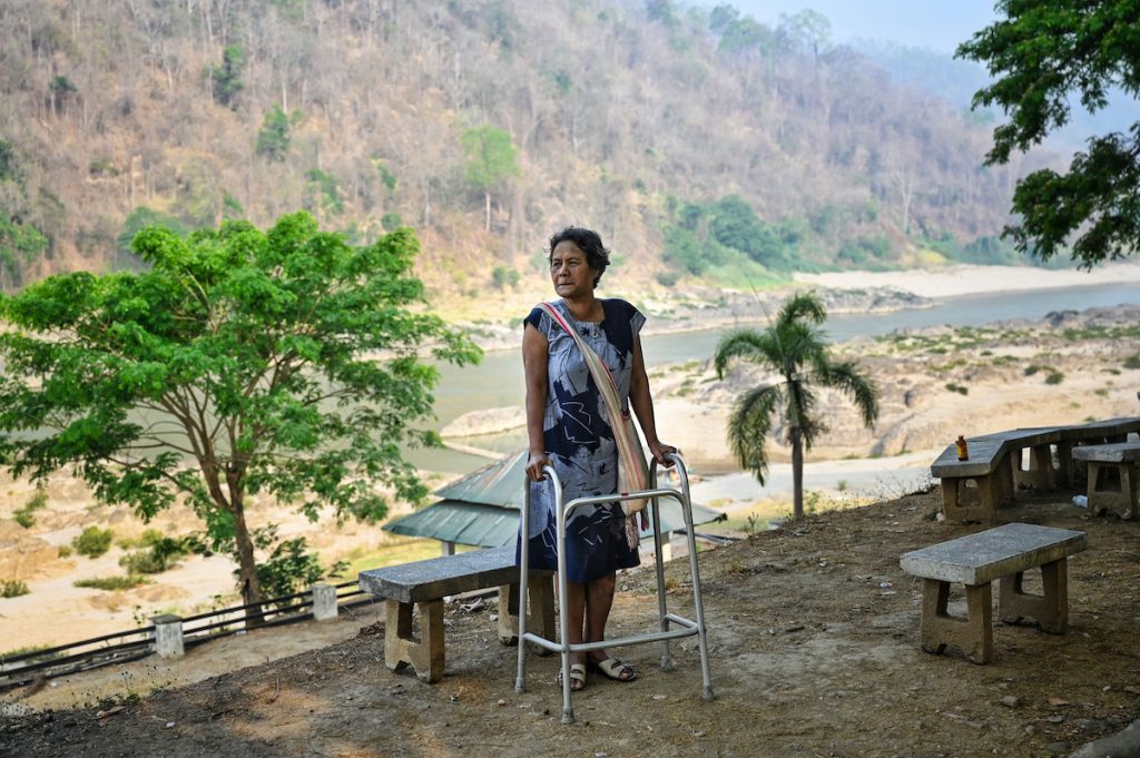 Hkara, an ethnic Karen resident of Mae Sam Laep town, in Thailand, walks alongside the Salween River in Mae Hong Son province on March 31, across from where Myanmar refugees earlier attempted to cross the Thai-Myanmar border after air strikes in Karen State. (AFP)