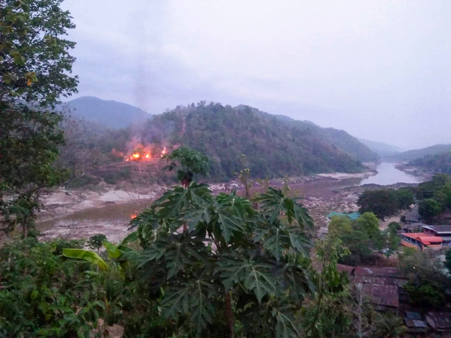 A Myanmar army base burns on a bank of the Thanlwin (Salween) River, as seen on April 27 from Mae Sam Laep town in Thailand's Mae Hong Son province, after the base was captured by KNU soldiers. (Kawthoolei Today / AFP)