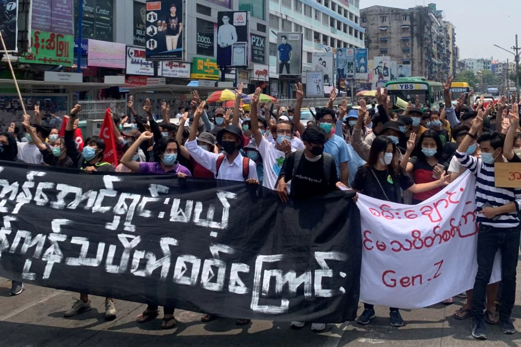 Anti-coup protesters hold up the three-finger salute while demonstrating in Yangon’s Tarmwe Township on April 26. (AFP)