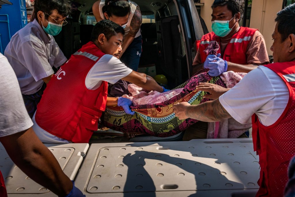 Volunteer medics carry the body of a protester killed by security forces during a crackdown on a demonstration in Yangon on March 27. (Frontier)