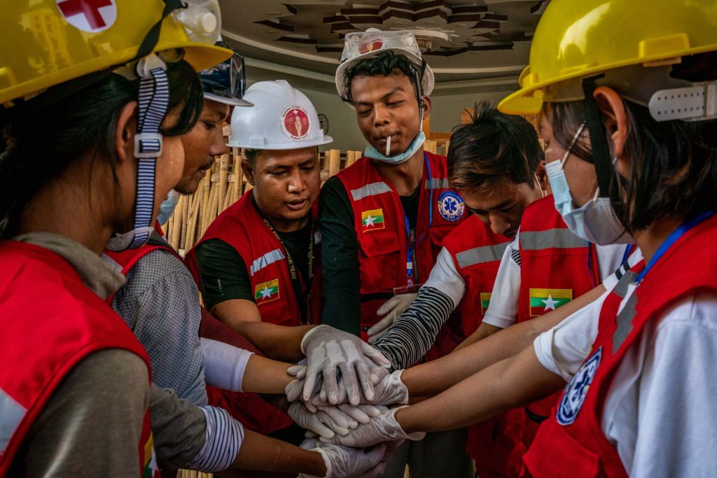 Volunteer rescue workers huddle on the morning of March 3 before working a protest in Yangon's Sanchaung Township. (Frontier)