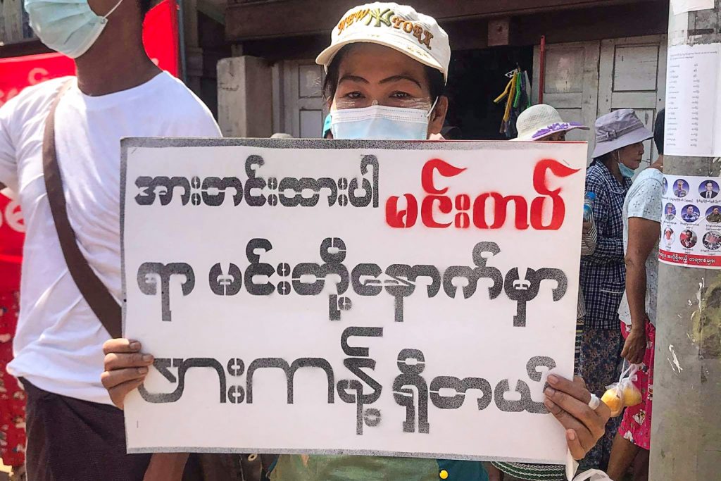 The Tatmadaw’s assault on the Chin State town of Mindat has inspired gestures of solidarity with the besieged militiamen and town residents from across Myanmar. Here, a protester in the Kachin State jade mining town of Hpakant on May 16 holds a placard reading, "Stay strong Mindat, Hpakant is behind you.” (Kachinwaves / AFP)