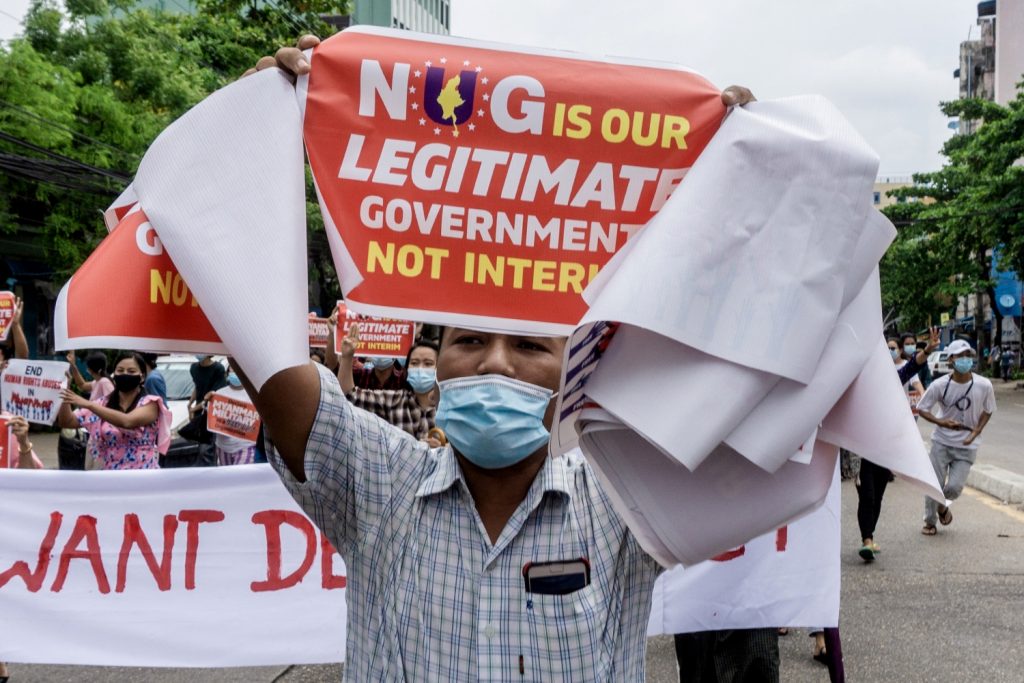 A protester carries a placard in support of the newly formed National Unity Government during a demonstration in Yangon's Thingangyun Township on April 30. (AFP)