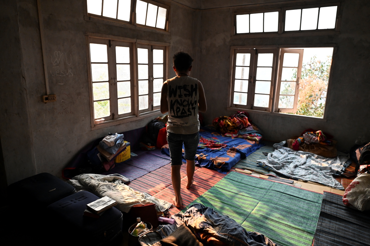 A police officer who fled Myanmar stands in a temporary shelter at an undisclosed location in India's northeastern state of Mizoram on March 13. Mizoram officials said in mid-March the state was harbouring at least 383 Myanmar public servants who had deserted their posts, of whom 98 percent claimed to be from the police and fire service. (AFP)