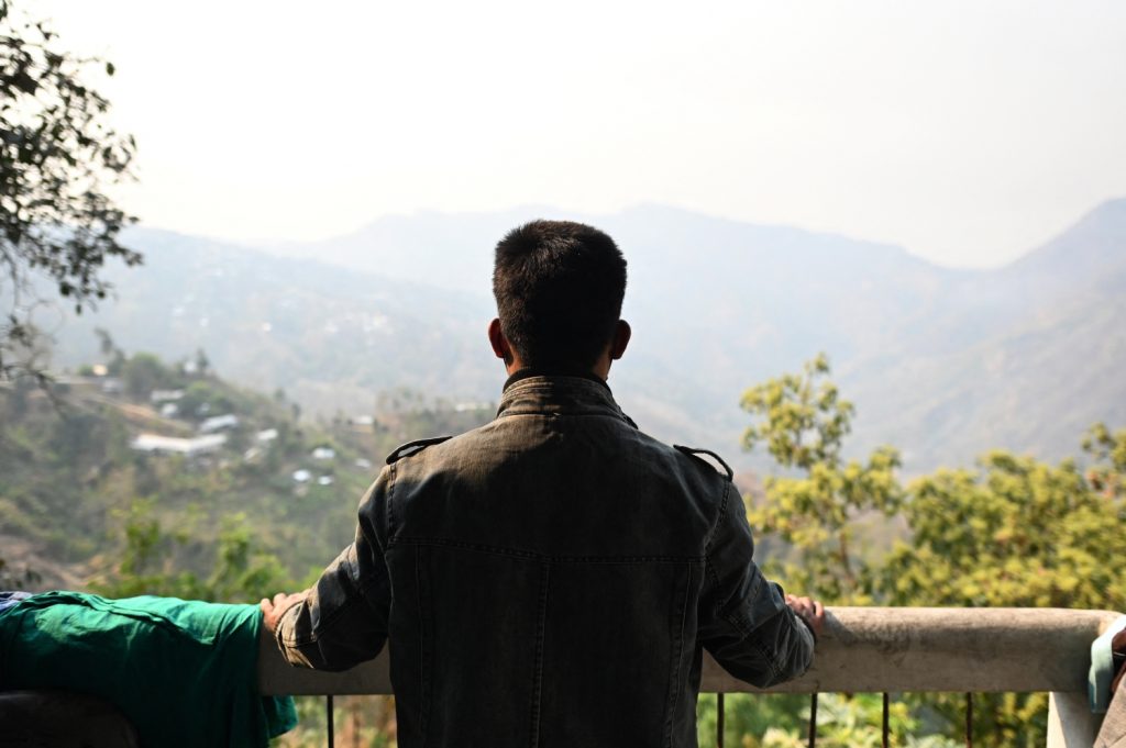 A Tatmadaw soldier who fled overland to India looks out from the balcony of a temporary shelter at an undisclosed location in Mizoram state on March 13. (AFP)