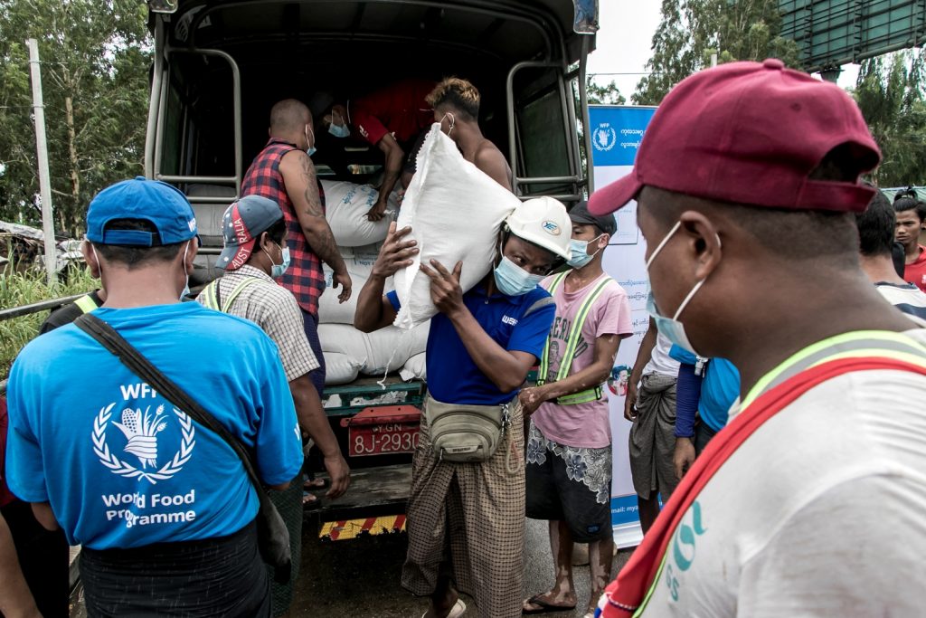 Poor residents of a Yangon suburb receive bags of rice from the World Food Programme on May 21. (AFP)