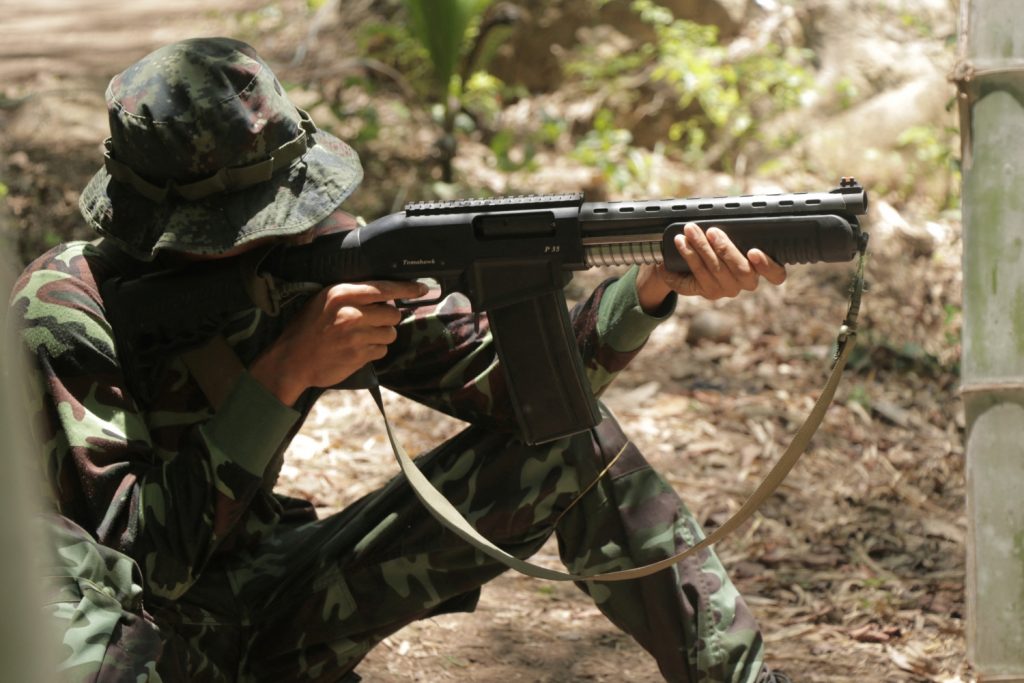 An anti-coup activist aims a weapon while undergoing basic military training in territory controlled by the Karen National Union in southeastern Myanmar. (AFP)