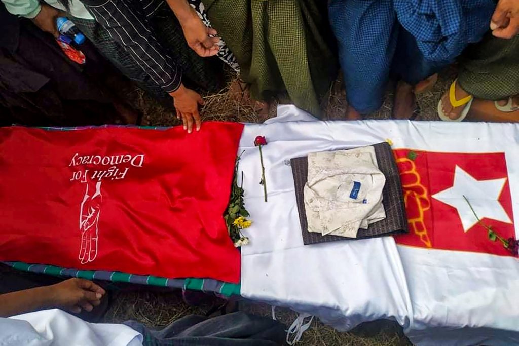 Mourners stand around the coffin of poet Khet Thi during his funeral on May 10 in Pearl town, Sagaing Region. (Facebook / AFP)