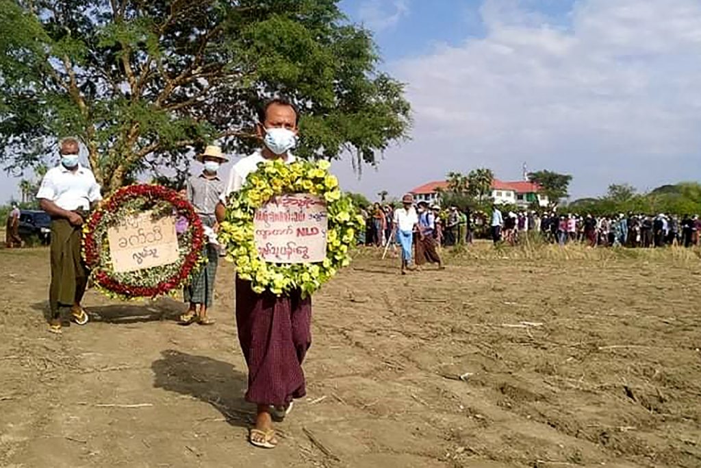 Mourners hold wreaths during the poet Khet Thi’s May 10 funeral in Sagaing Region. (Facebook / AFP)