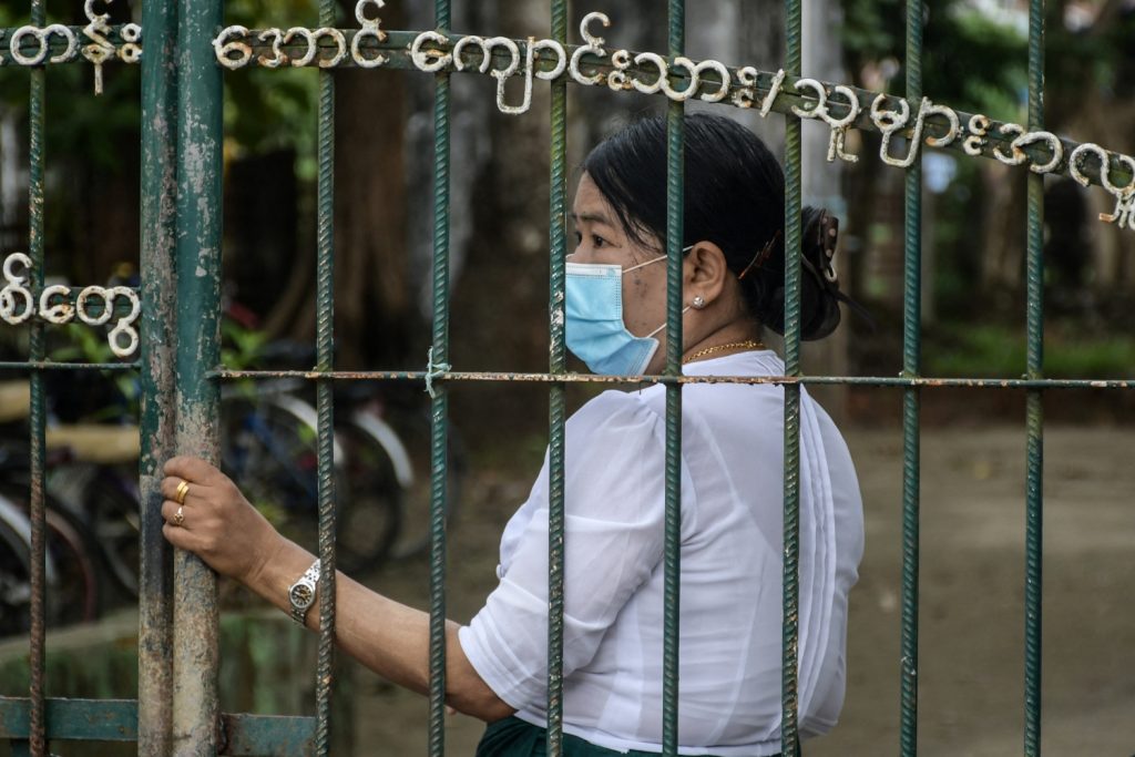 A teacher at a school gate on June 1, when the junta reopened schools across Myanmar with reportedly low attendance from children in most areas. (AFP)
