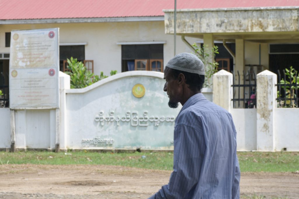 A displaced Rohingya man walks through the Thet Kay Pyin IDP camp in Sittwe, Rakhine state, in front of a government hospital. (AFP)