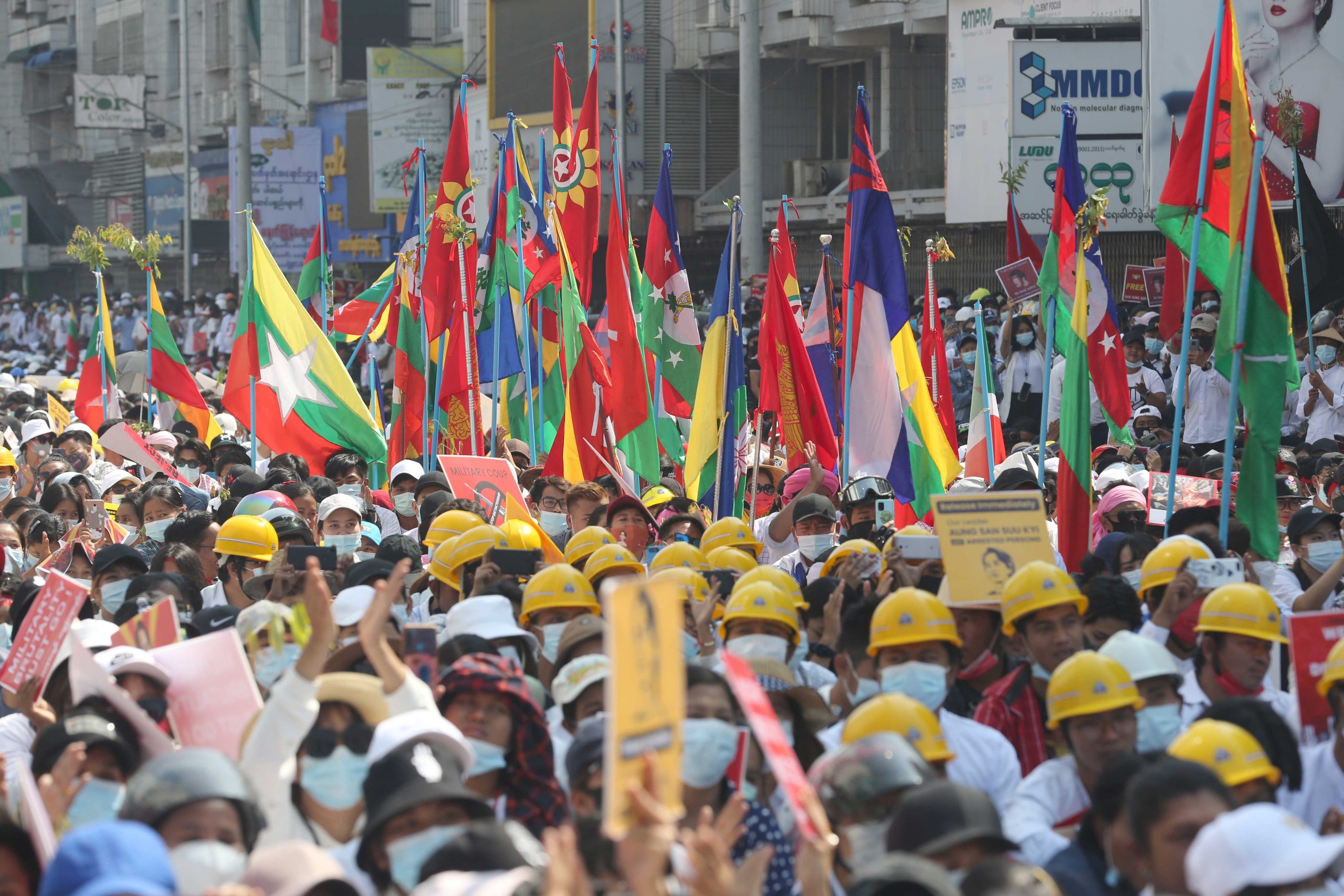 Pro-democracy protestors hold up flag representing various ethnic groups and organizations at a protest in Mandalay on February 22, 2021. (Frontier)